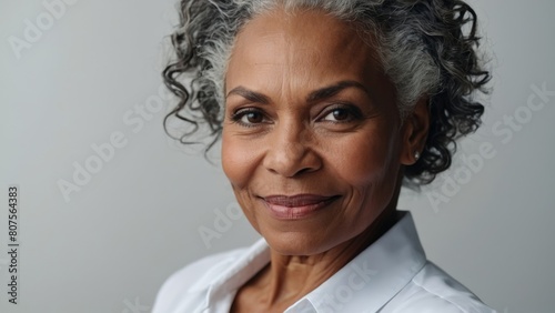 Beautiful gorgeous mid aged mature African American black woman looking at camera isolated on white close up portrait. Healthy face skin care beauty, skincare cosmetics, cosmetology concept