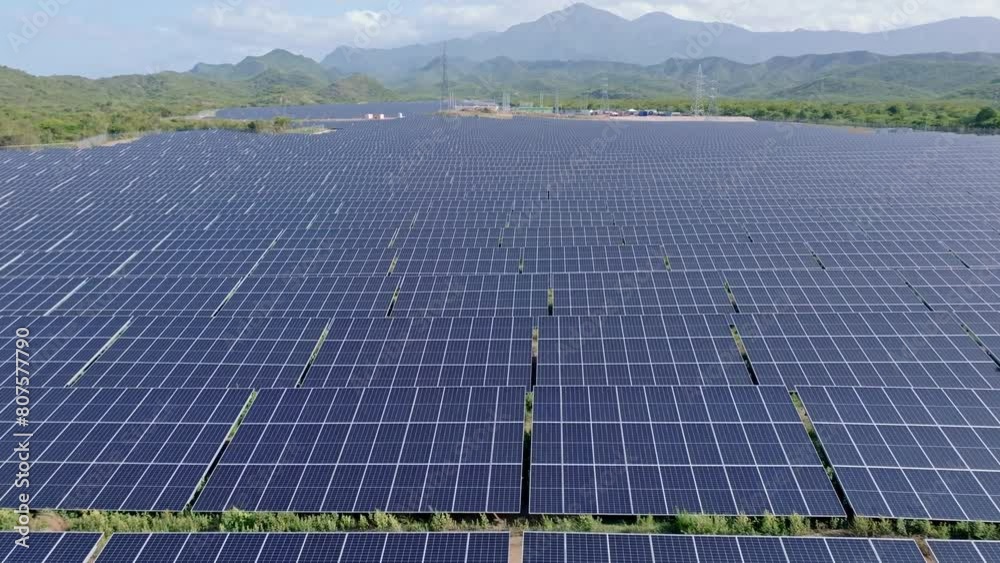 Large solar panel field in picturesque mountain landscape, aerial forward Large solar panel field in picturesque mountain landscape, aerial forward