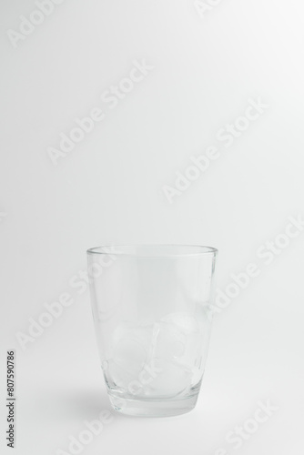 Glass with ice on white background