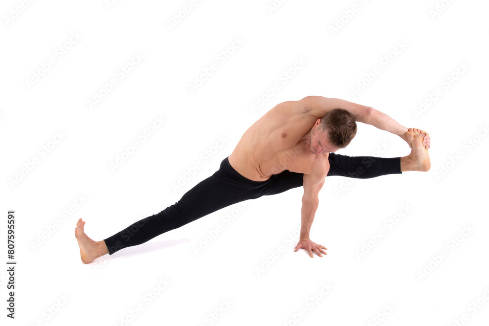 A handsome young man with an athletic body is doing fitness and yoga. White background. A handsome young man with an athletic body is doing fitness and yoga. White background.