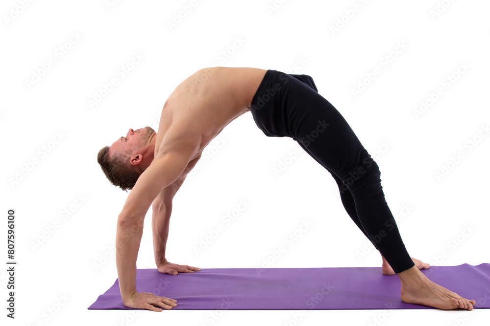 A handsome young man with an athletic body is doing fitness and yoga. White background. A handsome young man with an athletic body is doing fitness and yoga. White background.