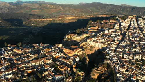Aerial drone view of The Puente Nuevo, New Bridge in Ronda. White villages in the province of Malaga, Andalusia, Spain during Golden hour. Slow Ascending Shot