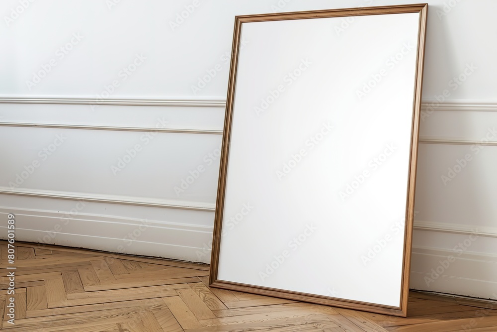 Blank picture frame leaning against white wall on wooden floor. Blank picture frame leaning against white wall on wooden floor.