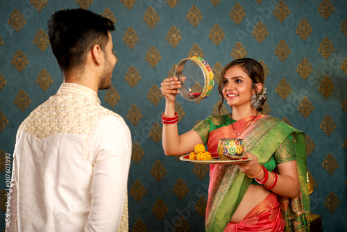 Young Asian Couple Wearing Traditional Indian Garb Celebrating The Karwa Chauth Festival
