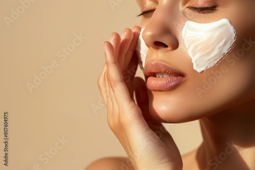 Close-up of woman applying sunscreen on face, skin protection.
