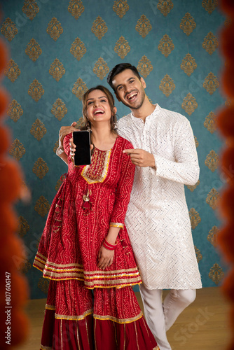 A Gorgeous Couple Posing For The Camera While Wearing Traditional Attire During The Dwali Festival
 photo