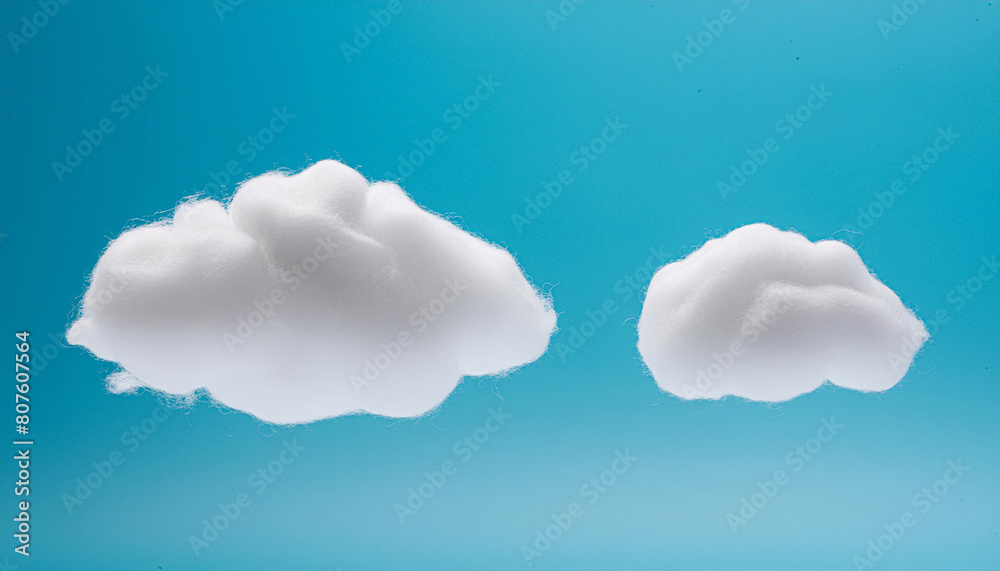 Two fluffy clouds on a vibrant blue backdrop, made from dacron. Two fluffy clouds on a vibrant blue backdrop, made from dacron.