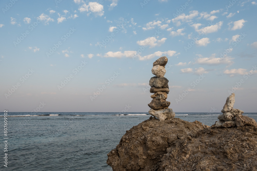 stacked corals at the beach with view to the sea and sky with white clouds stacked corals at the beach with view to the sea and sky with white clouds