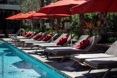 a row of lounge chairs sitting next to a swimming pool