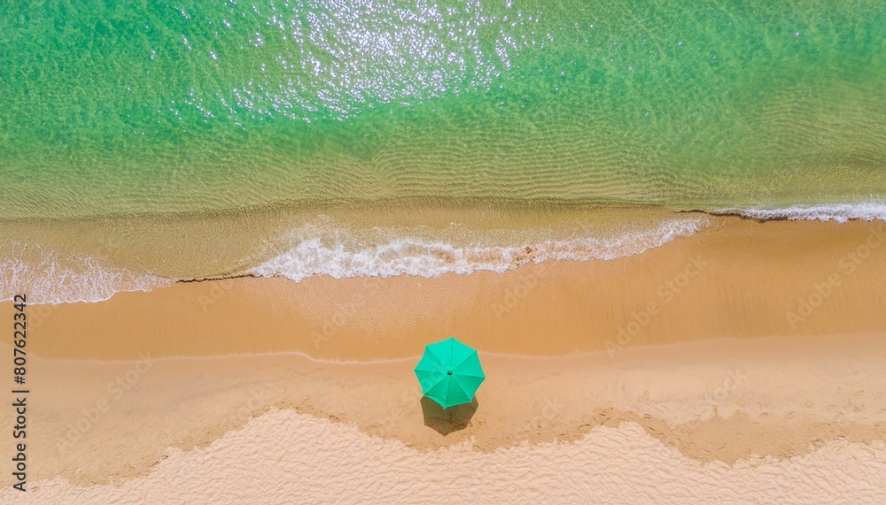 An emerald beach with a beach Umbrella  on it. a summer recreation site, drone shot