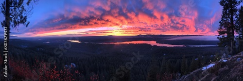 A stunning sunset over a tranquil lake nestled in the mountains