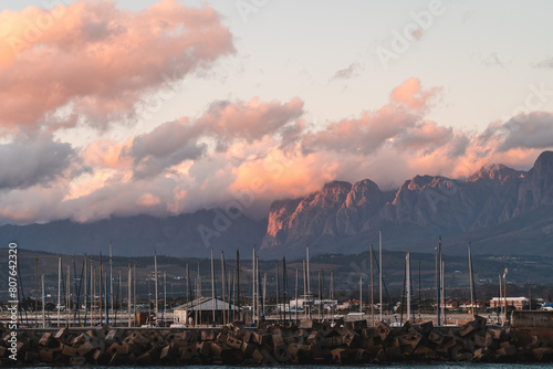 Sunset light hitting the Hottentots holland mountains with Gordons bay harbor in the forefront