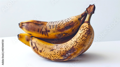 Ripe spotted bananas on a clean surface. Perfect for food blogging, recipe backgrounds. Simple minimalistic fruit photography. AI photo