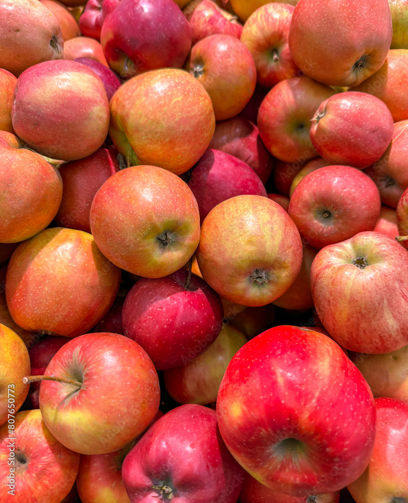 Ripe red apples on a counter in a market as a background. Texture Ripe red apples on a counter in a market as a background. Texture