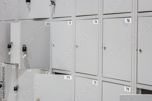 Metal luggage storage at shopping mall. Safe lockers in public place. Locker room with numbered boxes. Private safety in supermarket. Secure in gym. Safe storage background. 