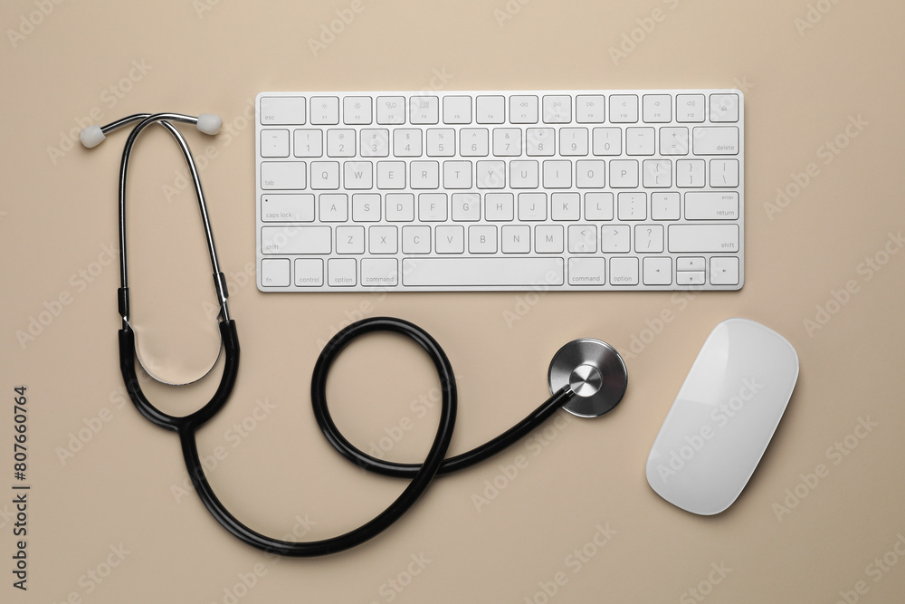 Stethoscope, keyboard and computer mouse on beige background, flat lay Stethoscope, keyboard and computer mouse on beige background, flat lay