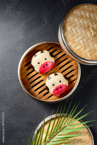 Creative cow-themed bao buns served in a bamboo steamer  showcasing an artistic spin on the traditional Asian snack