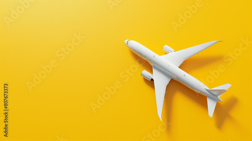 Minimalist White Model Airplane on Bright Yellow Background