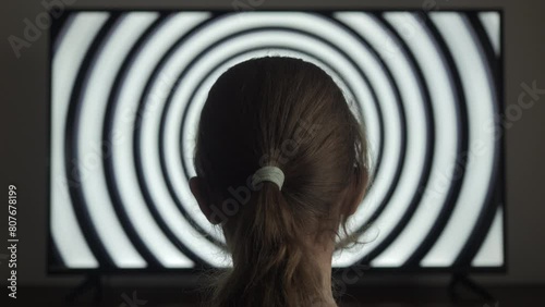 Girl Watching Hypnotic Spiral on TV Screen. Influence of Media on People. Broadcast False Information, Hoax, Propaganda Brainwashing Disinformation. Manipulation Crowd Fakes, False Information. photo