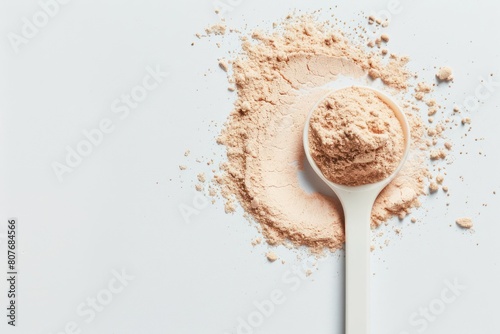Plastic spoon filled with plant-derived keto protein powder on an isolated background. Space to copy additional text or design elements