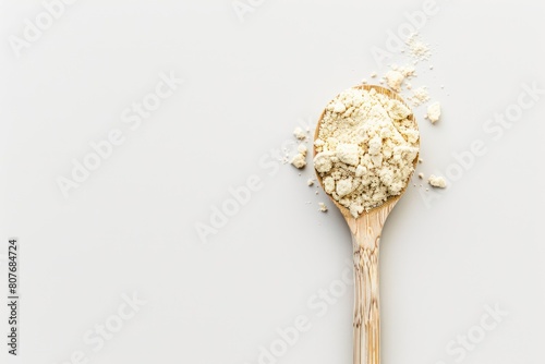 Plastic spoon filled with plant-derived keto protein powder on an isolated background. Space to copy additional text or design elements