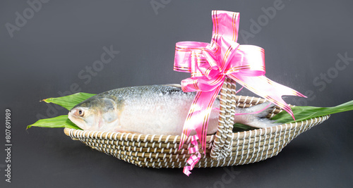 A Hilsha fish in a boat-shaped handmade busket used as a gift hamper in festive occations such as Jamai Shashthi, Pohela boishakh.