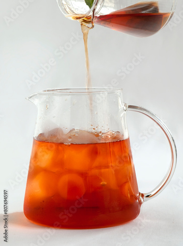 Iced tea with Ice cubes in glass pitcher