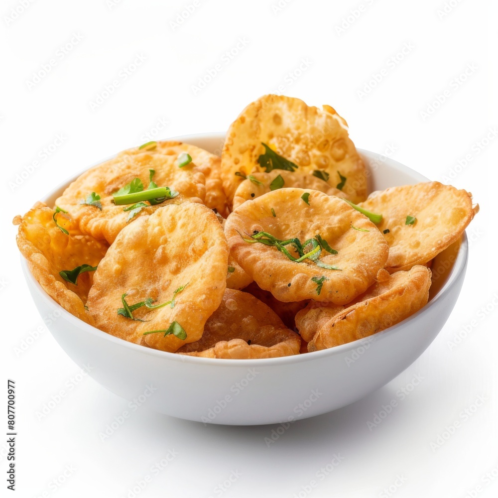A white bowl holding a selection of various Indian fried foods, including Puri, displayed on a table A white bowl holding a selection of various Indian fried foods, including Puri, displayed on a table