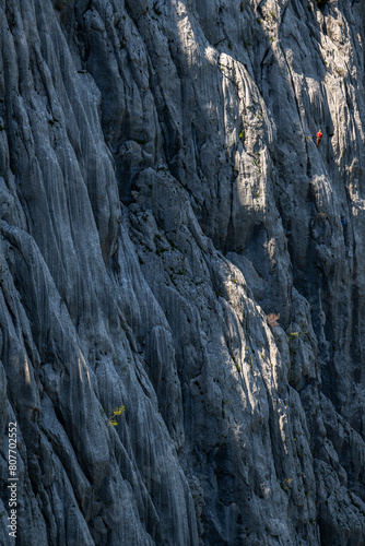 Silhouette of a climber on a steep rock. Mount Anica Kuk, Paklenica National Park, Croatia.