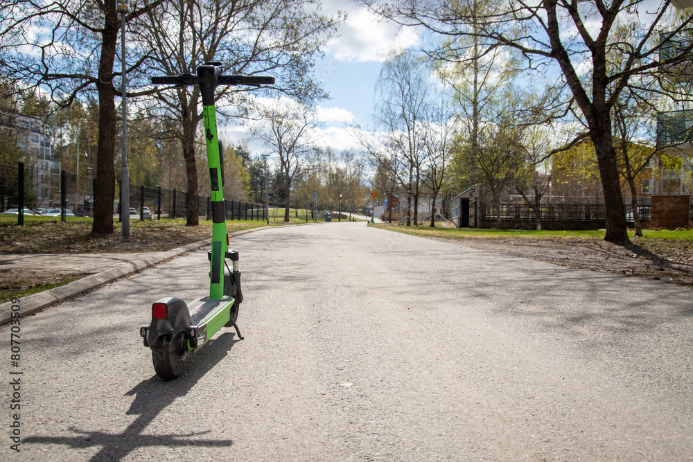rental electric scooter parked on sidewalk