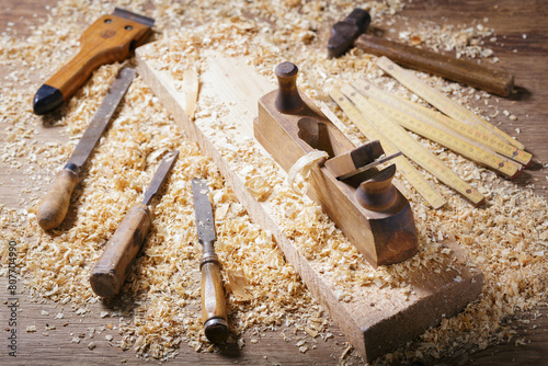 old tools: wooden planer, hammer, chisel  in a carpentry workshop © Nitr