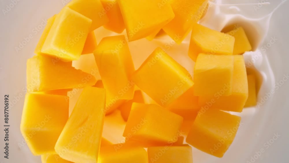Super Slow Motion Shot of Mango Cuts Followed by Camera Falling into Yogurt at 1000fps. Super Slow Motion Shot of Mango Cuts Followed by Camera Falling into Yogurt at 1000fps.