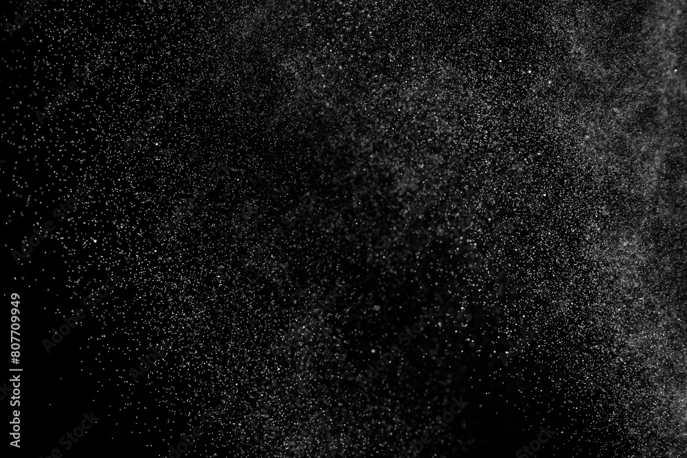Black and white grunge texture background. Abstract splashes of water on dark backdrop. Light clouds overlay.	