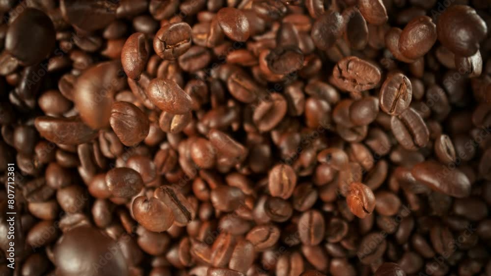 Super Slow Motion Shot of Falling and Rotating Coffee Beans Followed by Camera Motion at 1000fps. Super Slow Motion Shot of Falling and Rotating Coffee Beans Followed by Camera Motion at 1000fps.