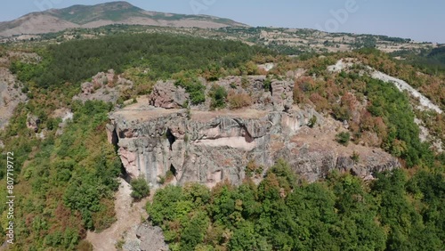 Aerial View Of Thracian Rock Tomb With Surrounding Foliage On Rhodope Mountains In Bulgaria. orbiting shot photo
