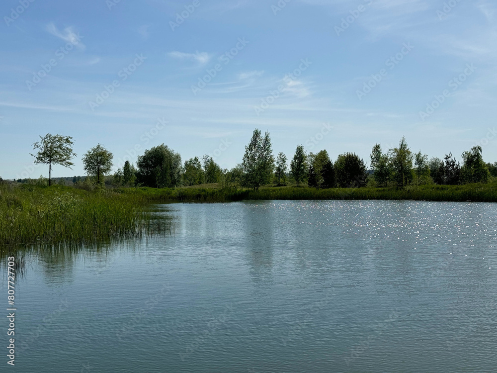 Fototapeta premium Landscape of lake, trees and sky at summer.