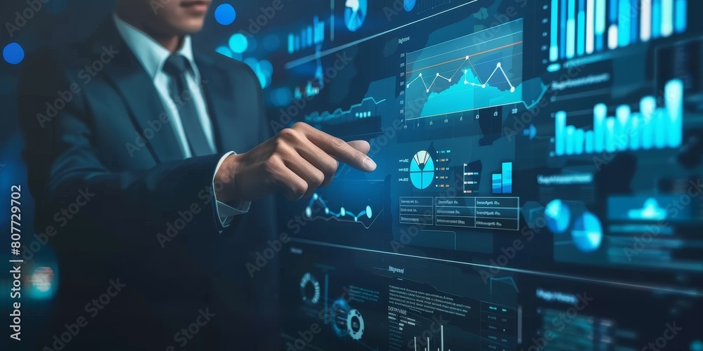 A man is pointing at a computer screen with a lot of graphs and numbers. Concept of analyzing data and making decisions based on the information presented. Scene is serious and focused A man is pointing at a computer screen with a lot of graphs and numbers. Concept of analyzing data and making decisions based on the information presented. Scene is serious and focused