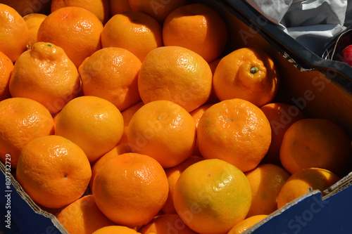 a box of tangerines. fruits on the market, sale of citrus fruits. background for the design.