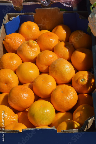 a box of tangerines. fruits on the market, sale of citrus fruits. background for the design.