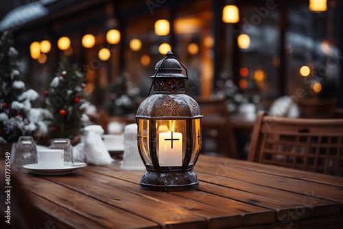 Lantern on a wooden table in a cafe. Christmas background.