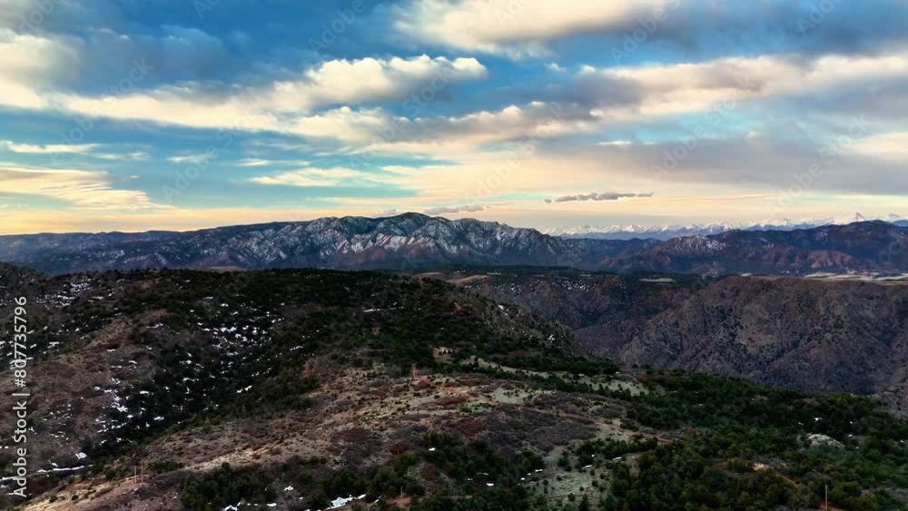 Drone flight over mountains at dawn with a dusting of snow Drone flight over mountains at dawn with a dusting of snow