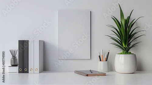 Back to school concept. Monochrome picture of a desk with houseplant in grey color pot, grey color copybooks and books on the grey table. photo