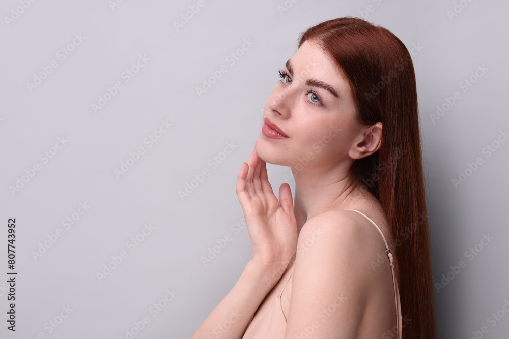 Portrait of beautiful woman on grey background. Space for text Portrait of beautiful woman on grey background. Space for text