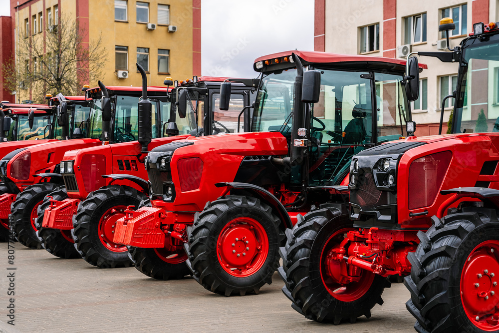 Tractors on farm production. New agricultural tractors are sold for work in the field Tractors on farm production. New agricultural tractors are sold for work in the field