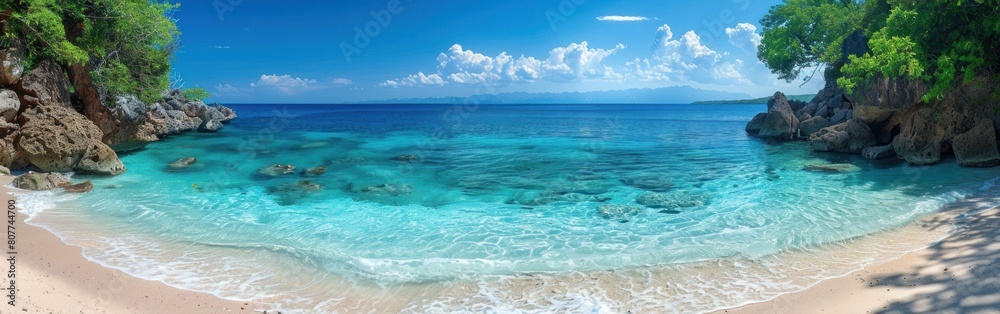 A sandy beach with clear blue water surrounded by trees A sandy beach with clear blue water surrounded by trees