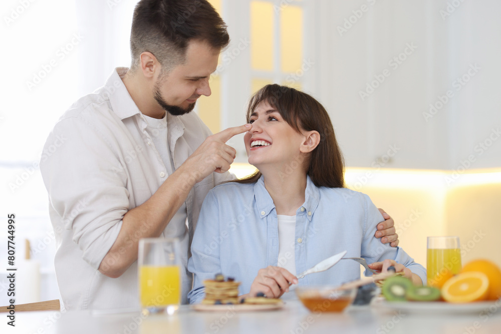 Happy couple spending time together during breakfast at home Happy couple spending time together during breakfast at home