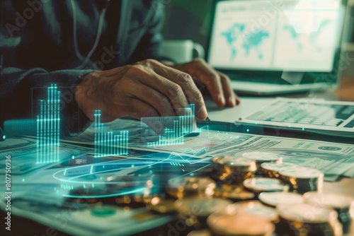 Digital hologram showing financial growth graph coins and document on table. Businessman working on a computer, screen showing the world map