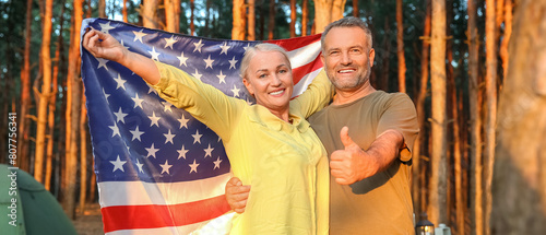 Mature couple with USA flag at barbecue party outdoors