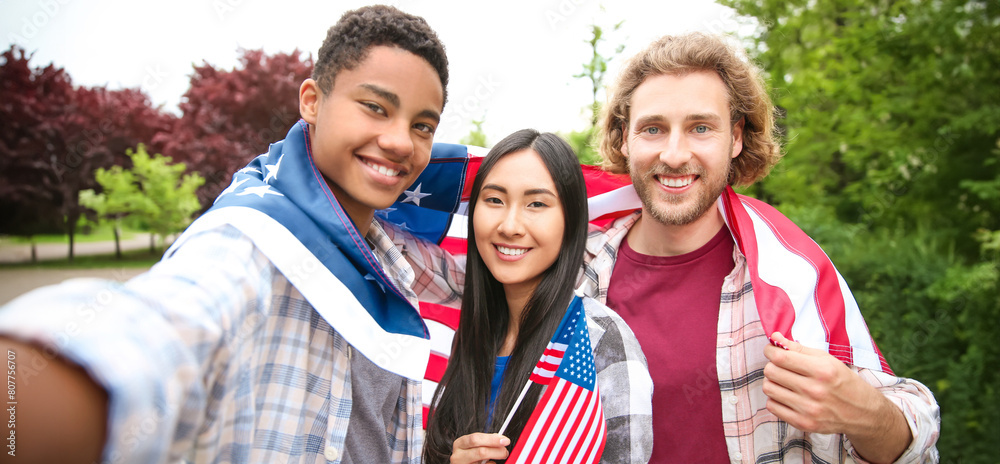 Group of students with USA flag taking selfie outdoors Group of students with USA flag taking selfie outdoors
