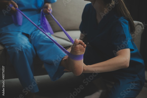 Unrecognizable senior physiotherapist working with a female patient.